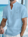 Man wearing a light-coloured linen stand collar T-shirt with short sleeves in a loose fit.