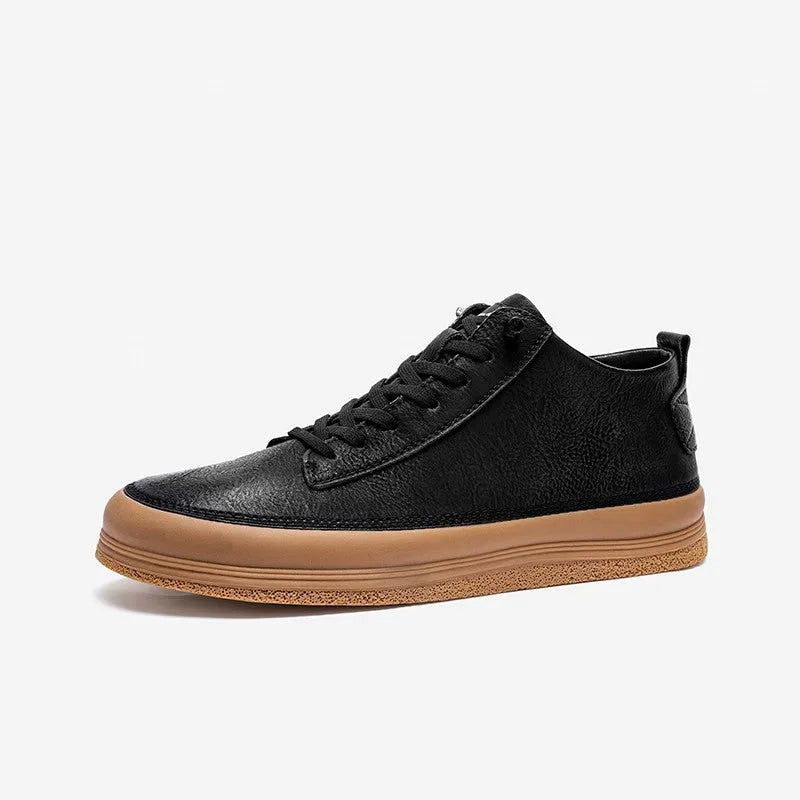 A pair of black men's round-toe casual leather shoes with white laces on a flat rubber sole.