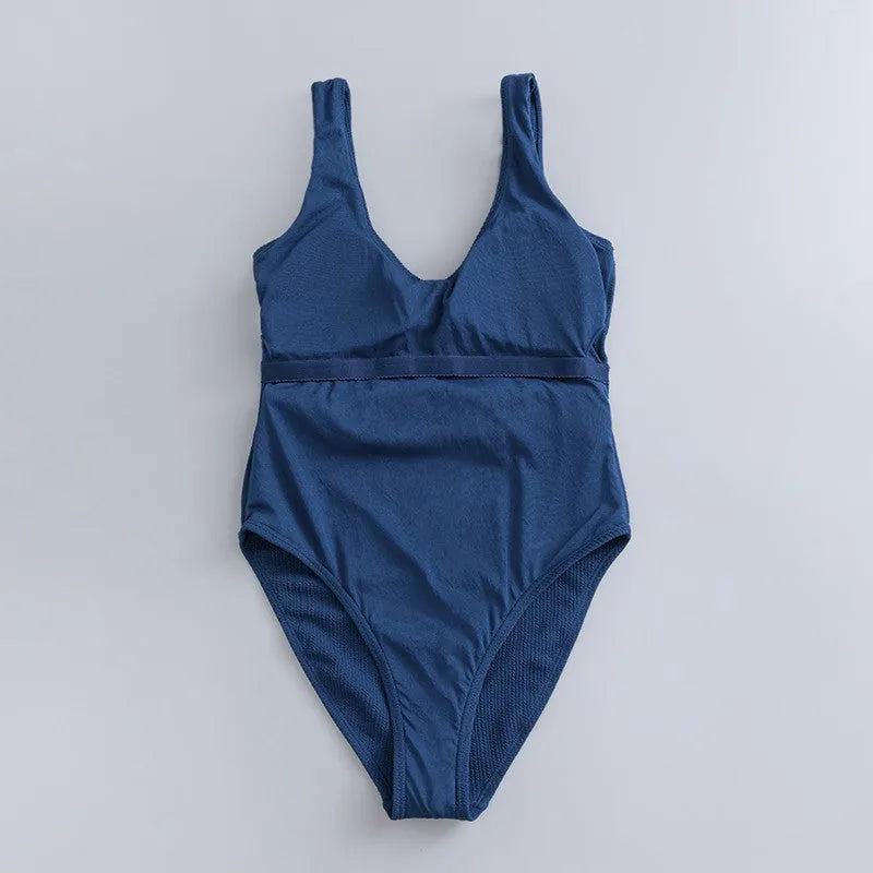 Navy blue women's one-piece slimming swimsuit with triangle neckline and removable chest pad.
