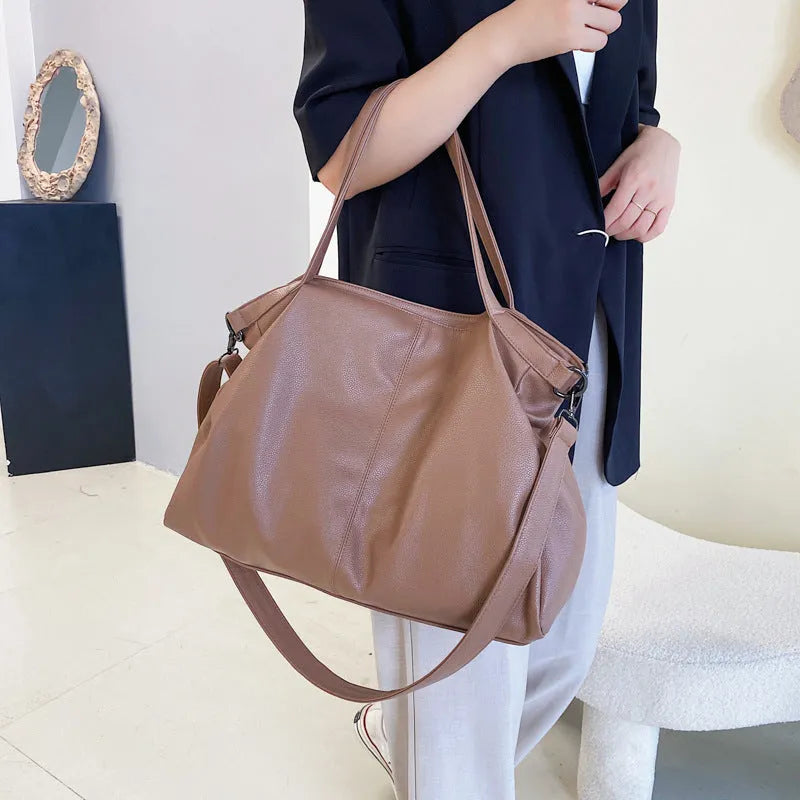 Large soft-surface PU messenger tote bag in black with zipper opening and adjustable shoulder strap
