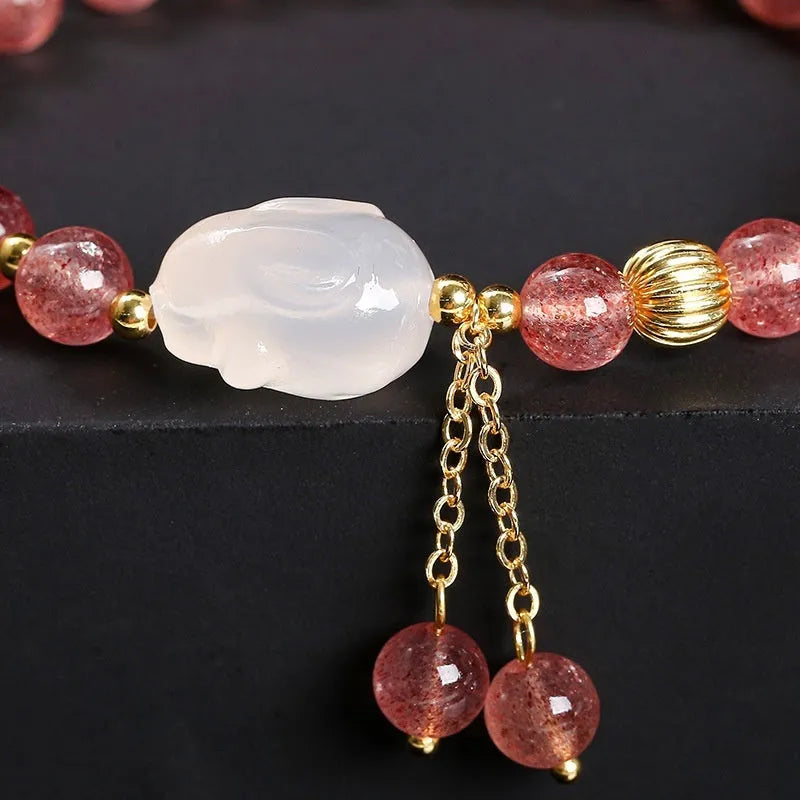 Natural strawberry quartz and agate bracelet for women with 6mm round beads and a white rabbit charm.
