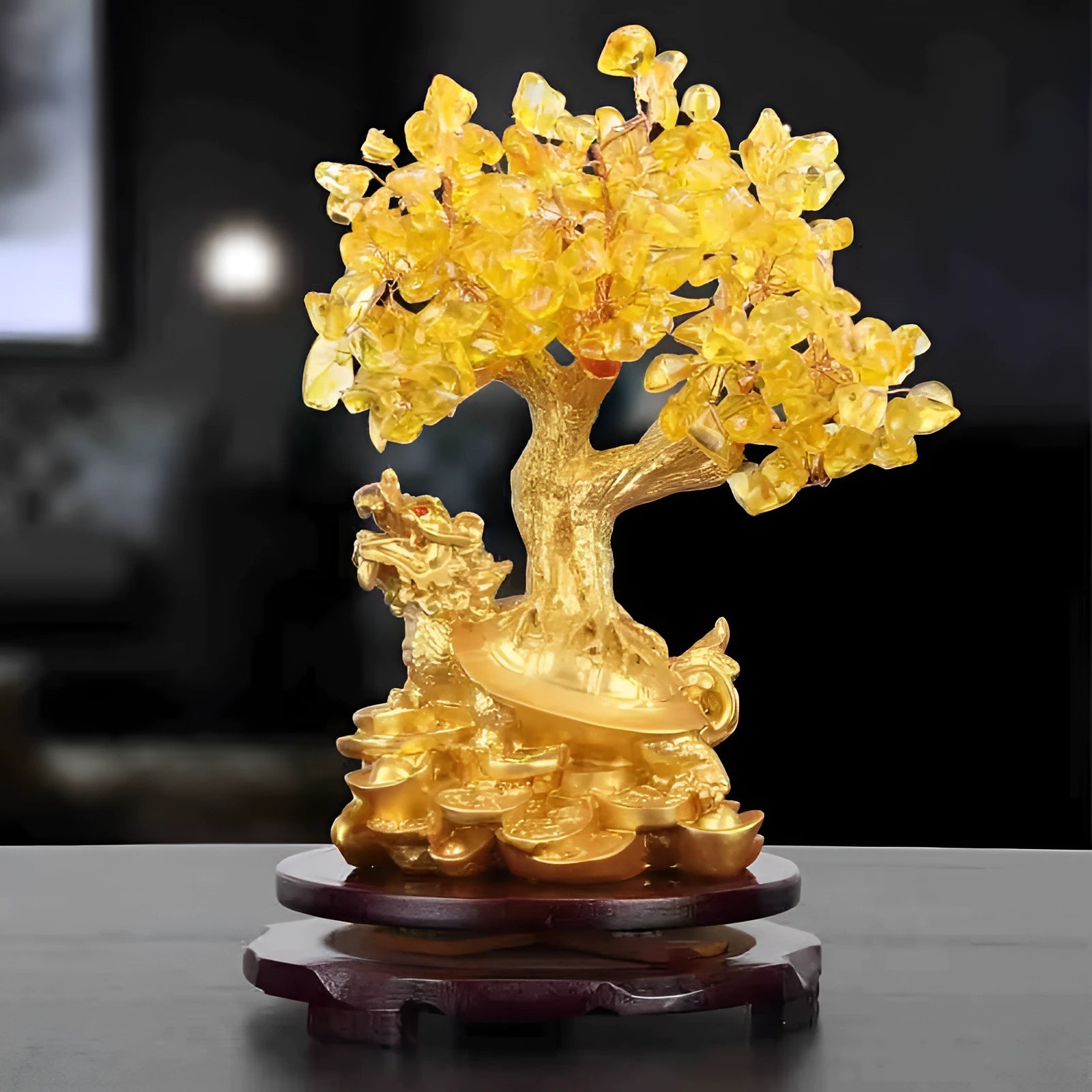 Citrine coloured resin small water turtle money tree Feng Shui ornament on a surface.