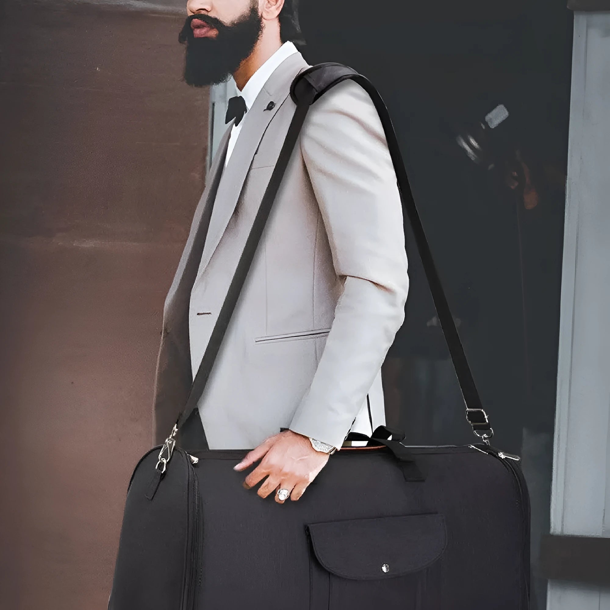 Dark blue folding Oxford cloth duffle bag with handles, shown in a travel setting.