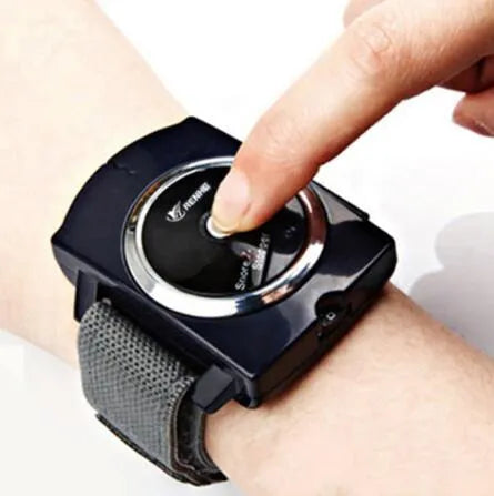 Black ABS anti snore wristband with biosensor and infrared therapy displayed on a flat surface