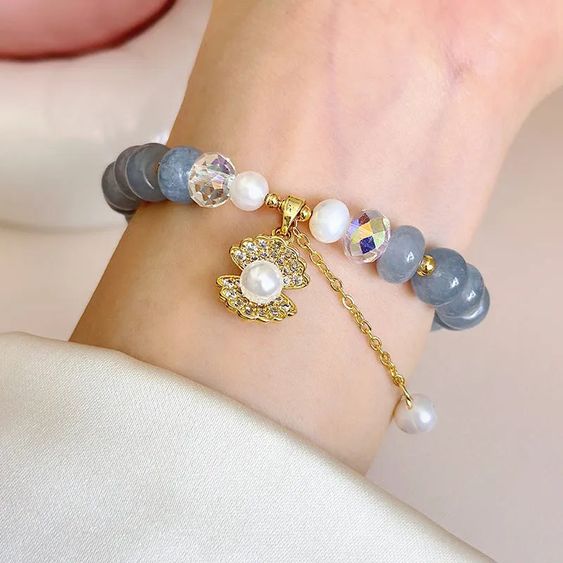 Natural aquamarine pearl shell bracelet on wrist showing adjustable design and handcrafted bead details