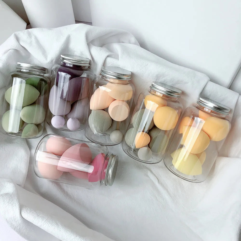 Set of 7 makeup sponge eggs in various colours inside transparent jar with multiple cut shapes