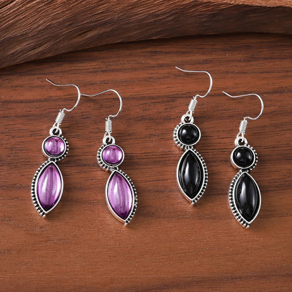A pair of vintage geometric pendant earrings in black and purple with a Bohemian style.