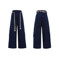 Men's dark blue straight-leg cotton jeans with heavy stitching on the belt and tassel pocket details.