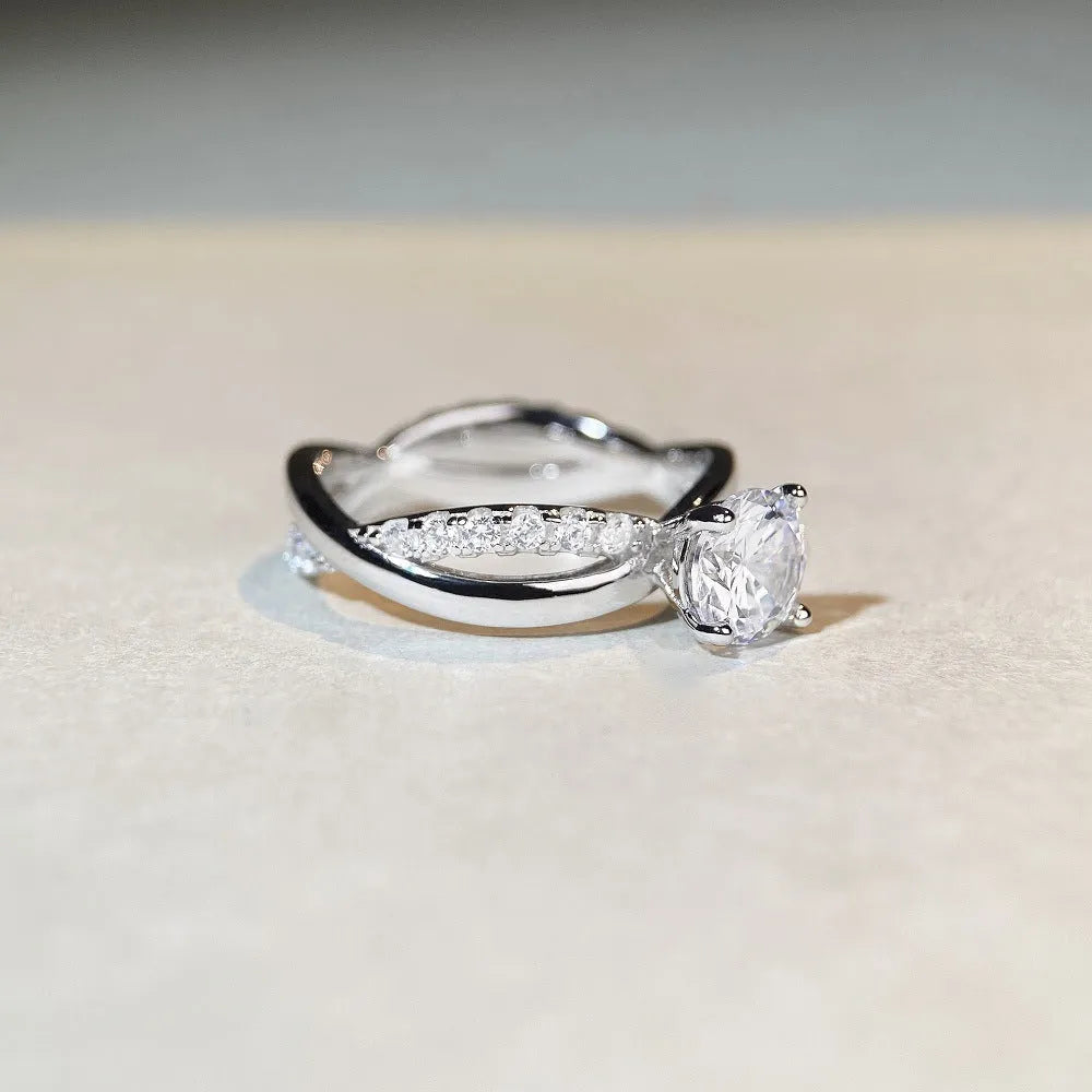 Geometric twisted silver band ring with 1 karat moissanite stone in four-claw setting, side view showing cross details