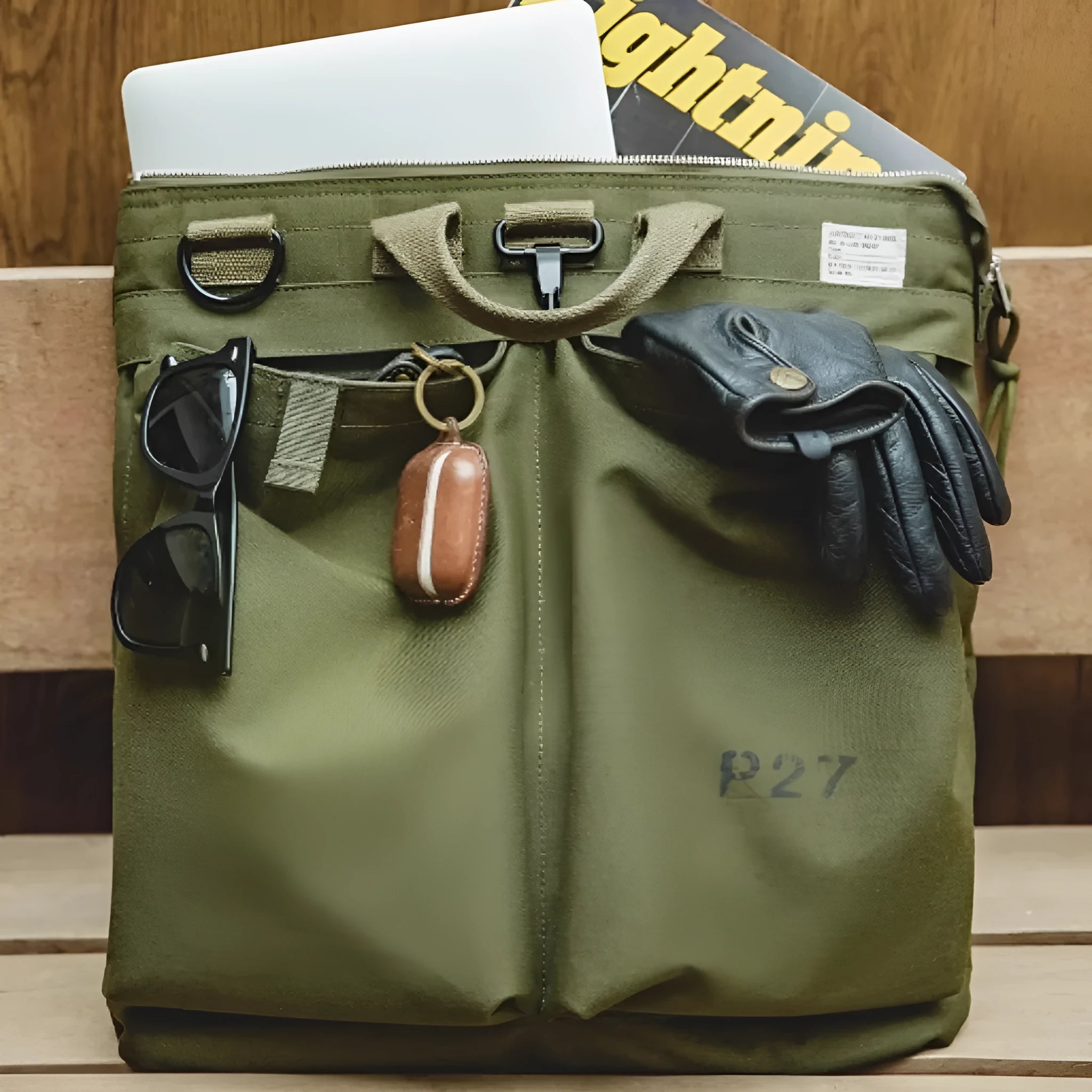 Marden canvas crossbody messenger bag in military green showing laptop compartment and shoulder strap