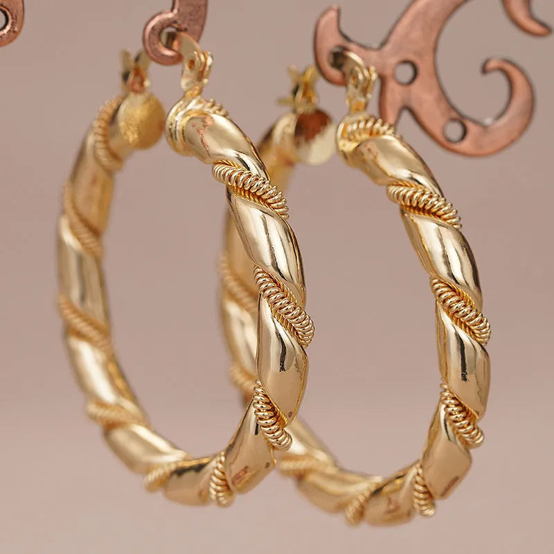 Geometric copper earrings for women featuring ring and line design in a golden colour.