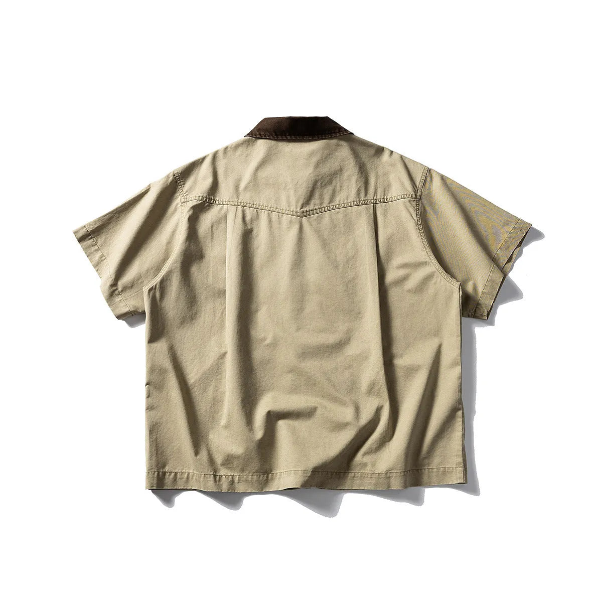 A loose grey or khaki cotton short-sleeved overall shirt, shown as an oversized cardigan style.