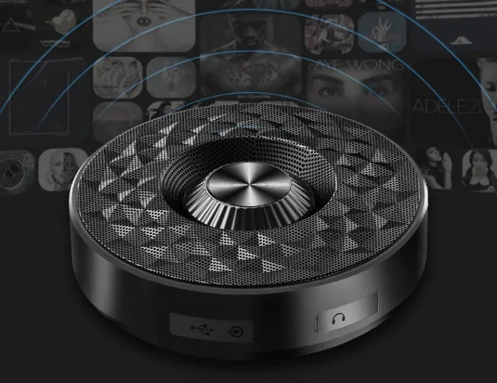Compact black, orange, and silvery white portable Bluetooth speaker on a table