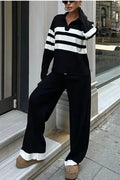 Women's black and white striped knitted two-piece set with a polo collar, featuring a long-sleeve top and trousers.