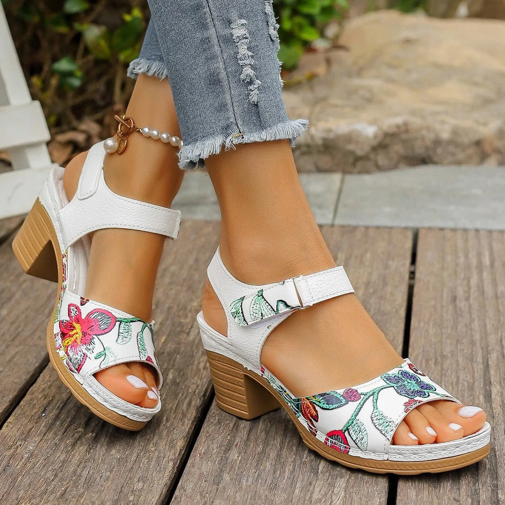 White women's high heel sandals with velcro buckle closure showing rubber sole