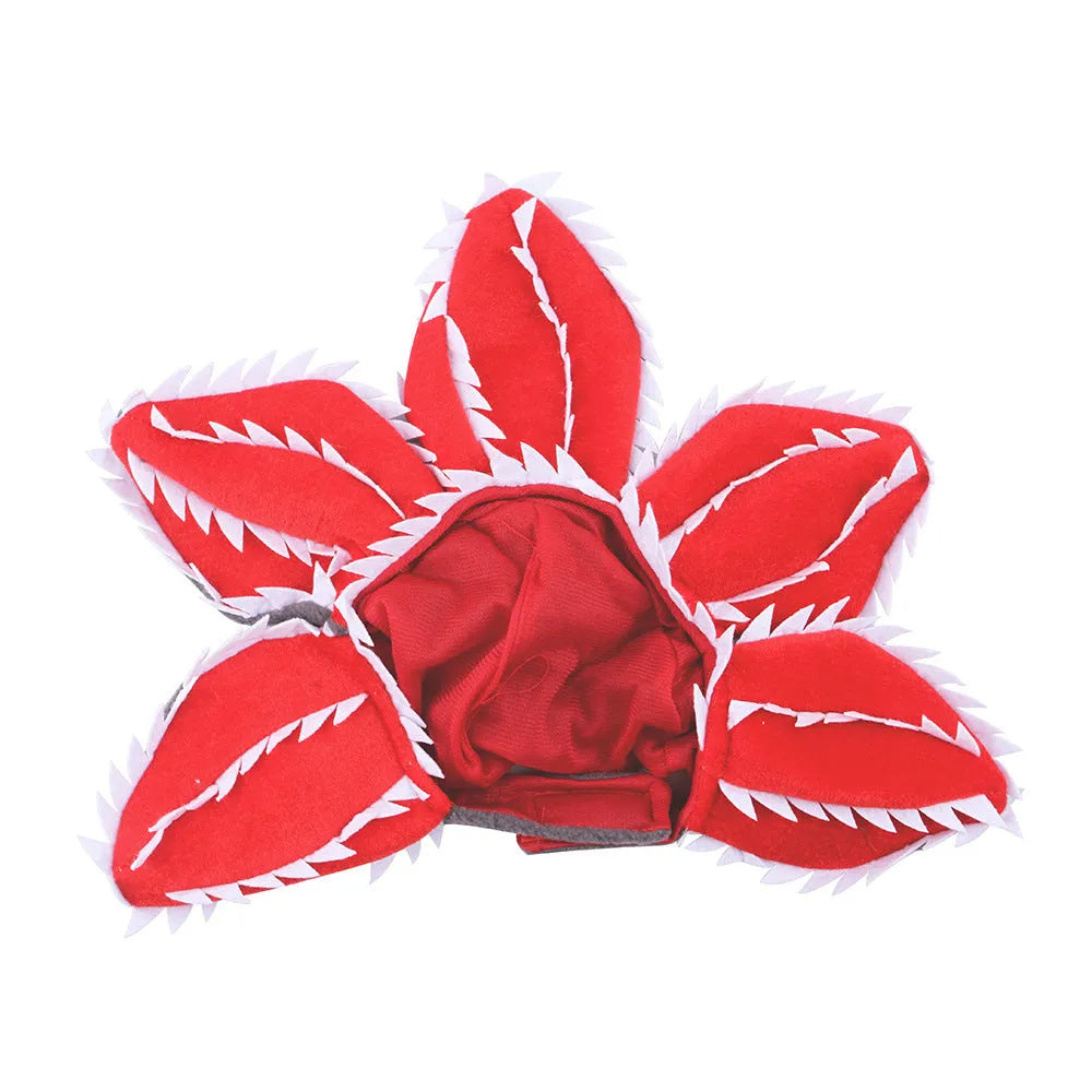 Dog wearing Halloween demon hat costume with open chomper mouth and flower headband accessory