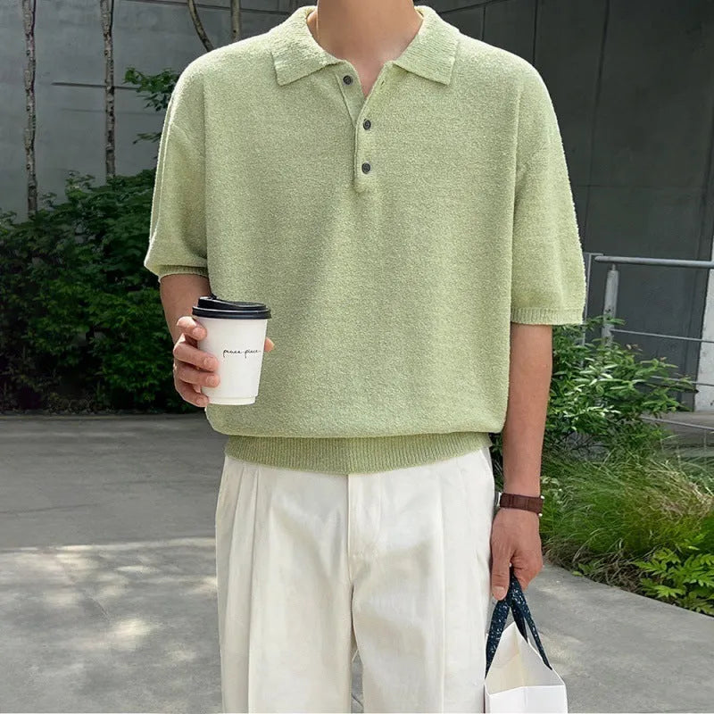A caramel-colour men's retro knitted polo shirt with short sleeves, showing its loose fit and asymmetric design detail.