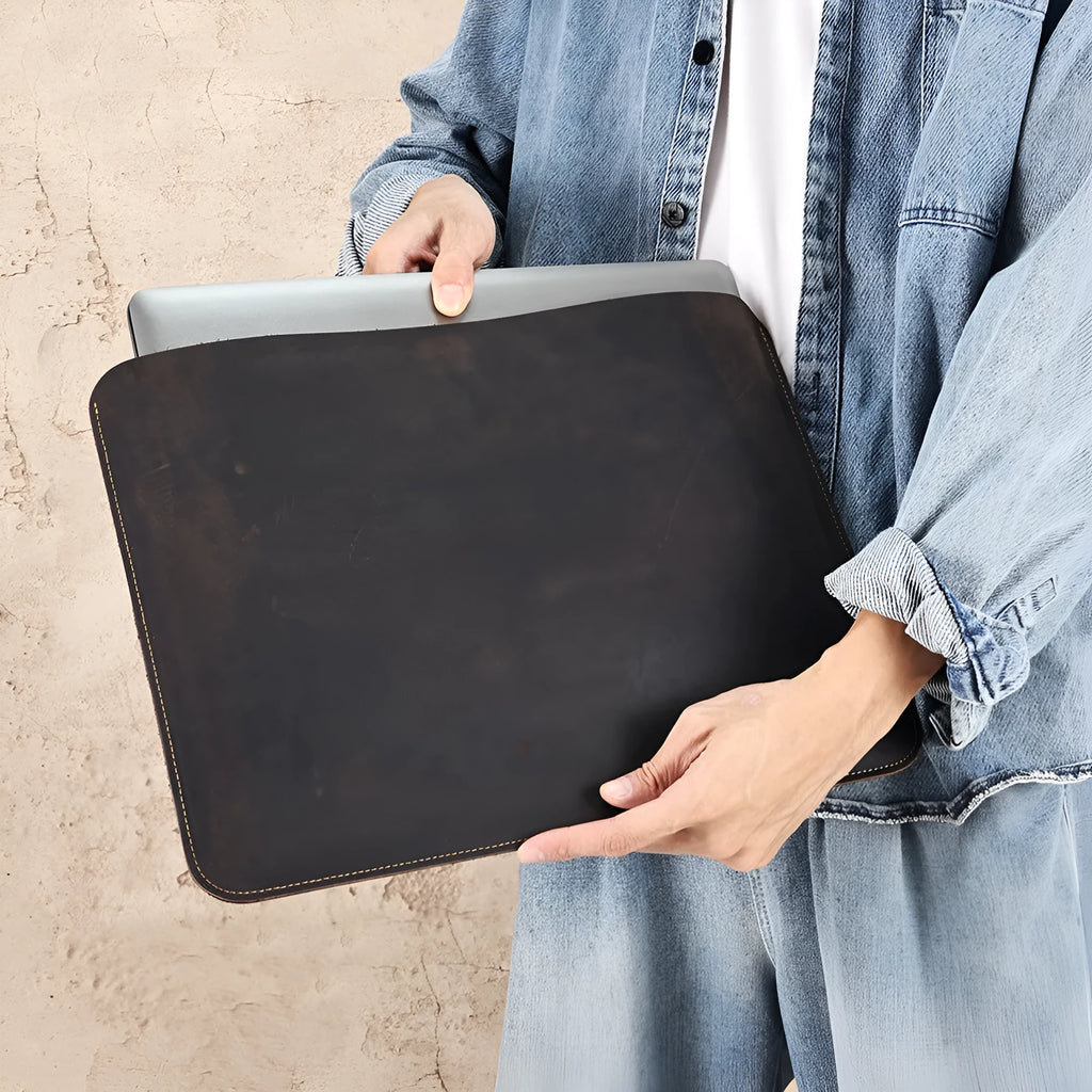 Brown horizontal computer liner bag made from cowhide leather showing laptop storage compartment