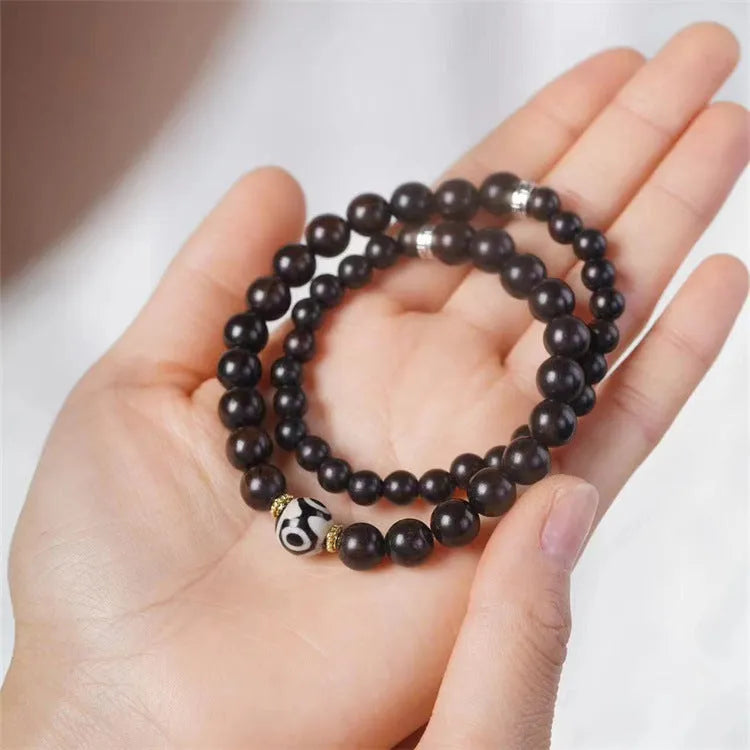Ebony wood Tibetan prayer bead bracelet showing 8mm diameter and natural wood grain