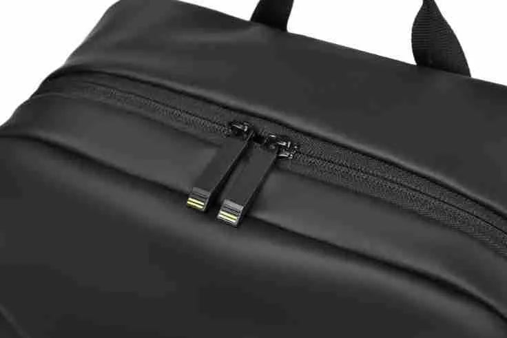 Large black waterproof PU leather computer backpack with simple design and sewing thread detailing