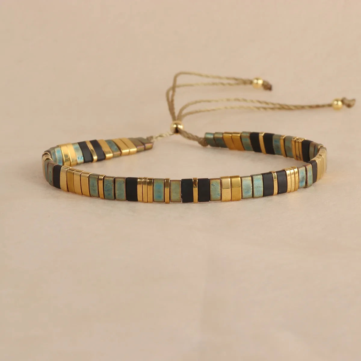 Geometric glass bead bracelet in milky white, black, retro green, light blue, or red colours.