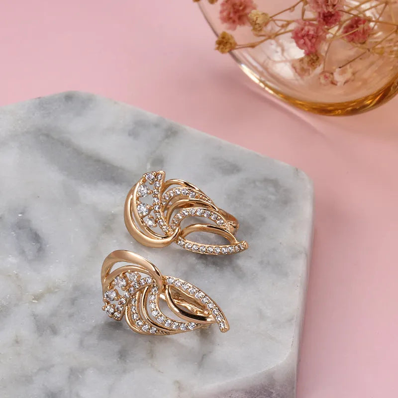 Gold-plated copper ear clips with geometric wing design and micro-inlaid zircon gemstones
