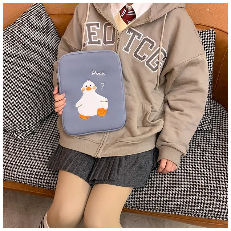 Blue cotton tablet case with embroidered cartoon duck design and a zip closure.