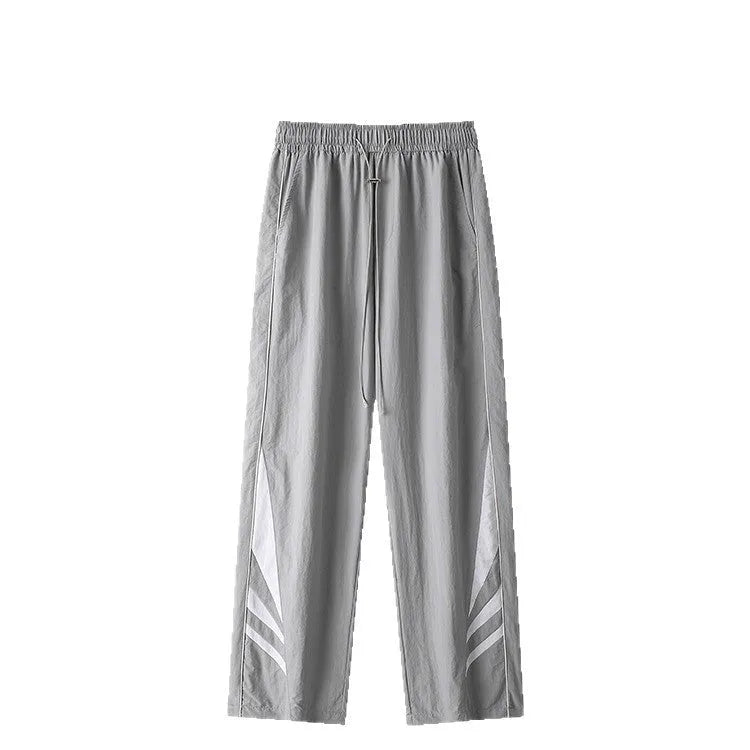 Men's straight-leg trousers in black or grey, featuring an elastic waist and loose fit.
