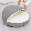 Brown cloth dog kennel with removable washable cover, shown on a wooden floor.