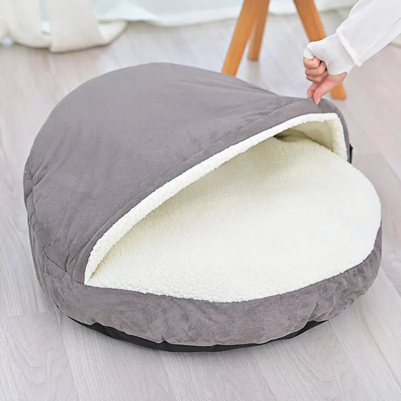 Brown cloth dog kennel with removable washable cover, shown on a wooden floor.