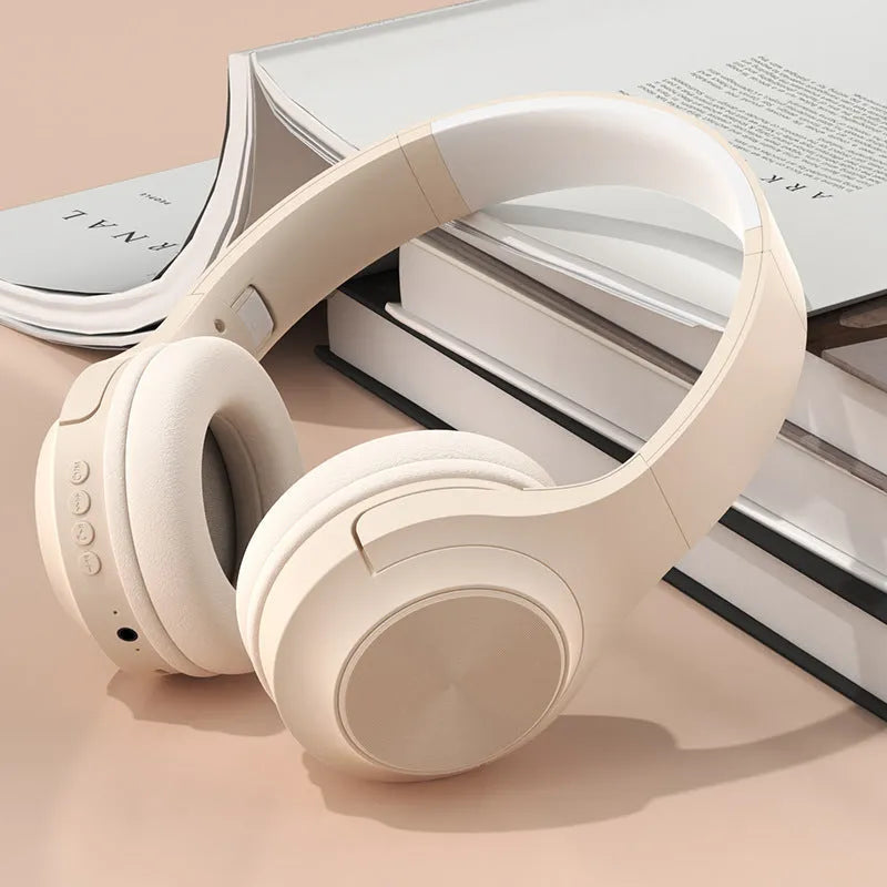Creative head-mounted wireless Bluetooth headset in Ivory White colour on a charging bin.