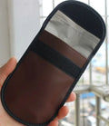 Black microfiber Faraday pouch for blocking car key and credit card signals, shown with a key fob inside.