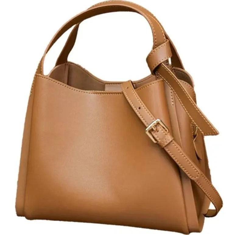 Women's soft cowhide genuine leather crossbody shoulder bag in a bucket shape.