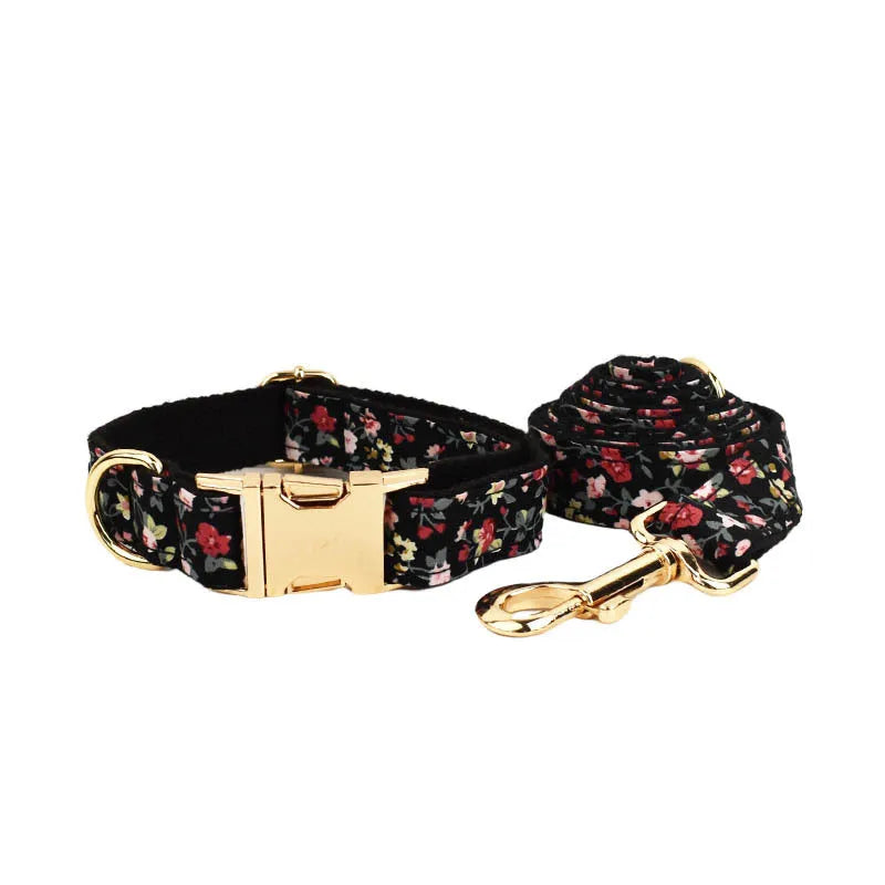 A cloth dog collar set with a removable bow, matching leash, and vest, featuring printed lettering.