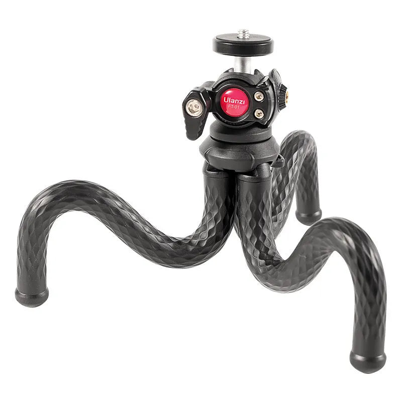 Black octopus-style mobile phone tripod with clip extended to 360mm on a table.