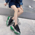 Women's black leather casual sports shoes with a thick clear jelly sole and cross-tie fastening.