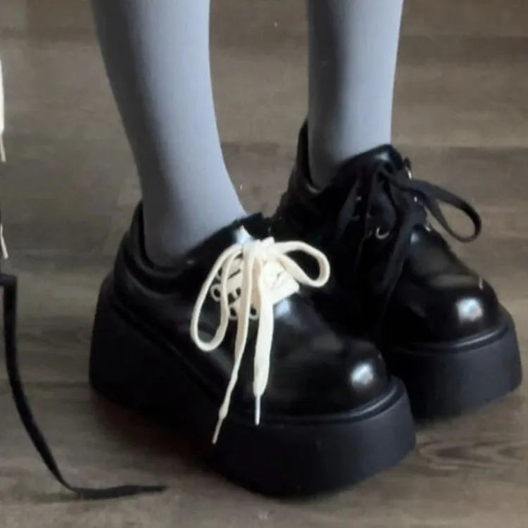 Matte black women's retro lace-up shoes with a thick sole and a muffin heel.