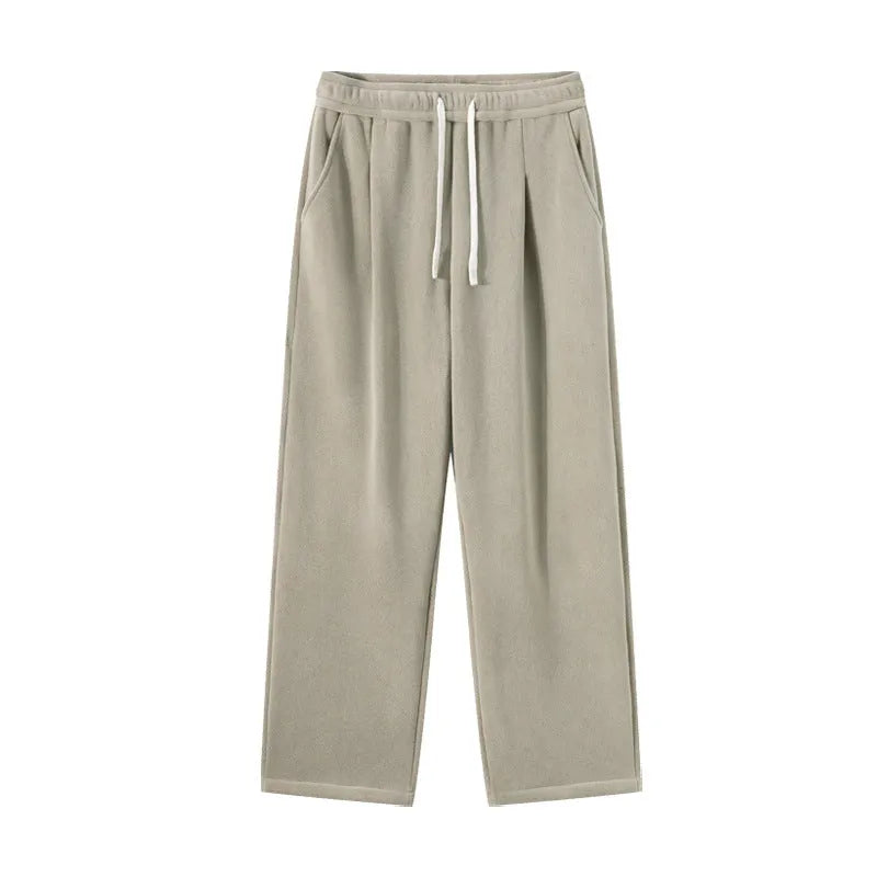 Man wearing apricot coloured double-sided polar fleece winter trousers with a loose fit and drawstring waist.