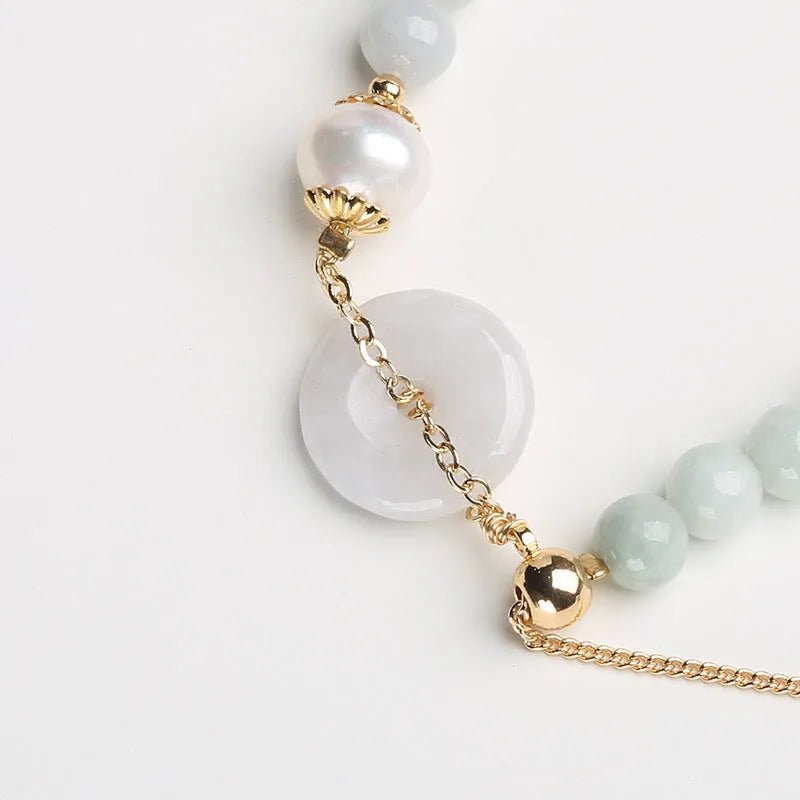 Natural emerald jade pearl bracelet with peace symbol buckle showing geometric charm arrangement