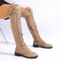 Black lace-up over-the-knee flat boots with a round toe, shown on a model.