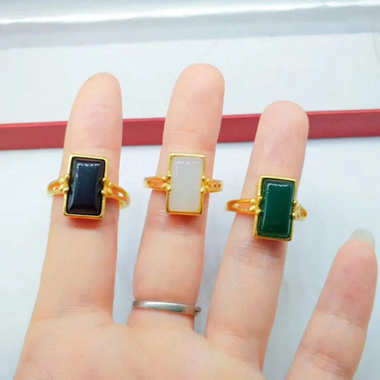 Gold-plated brass ring with a long green gemstone on an adjustable band.