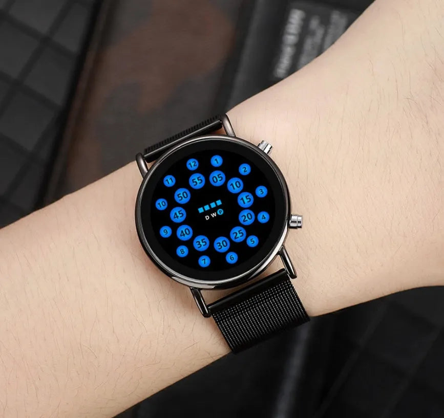 Black shell LED watch with blue illumination on stainless steel mesh strap showing 38mm round dial