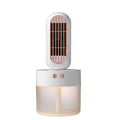 Small black and white humidifier fan with shaking head on a desktop