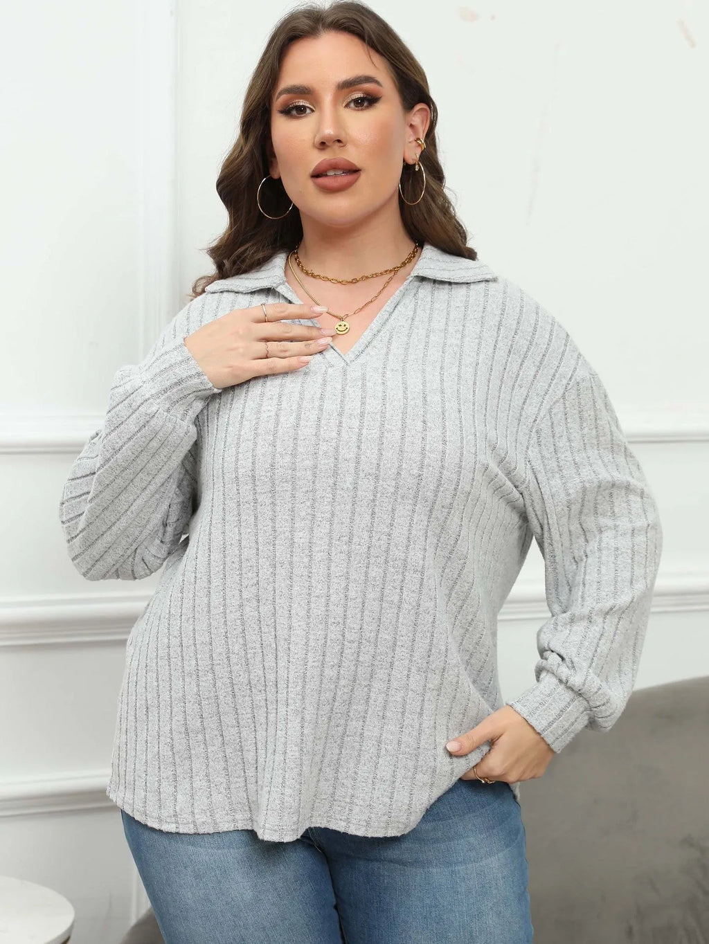 Plus size women's grey polo collar shirt with lantern sleeves in a street fashion style.