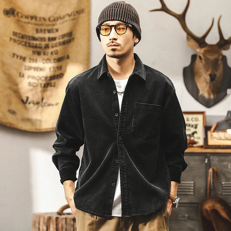 Man wearing a loose-fit red corduroy shirt jacket, showcasing its textured fabric and casual style.
