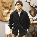 Man wearing a loose-fit red corduroy shirt jacket, showcasing its textured fabric and casual style.