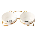 Pure white ceramic cat bowl with cat footprints design on a black iron frame stand with cat ears.