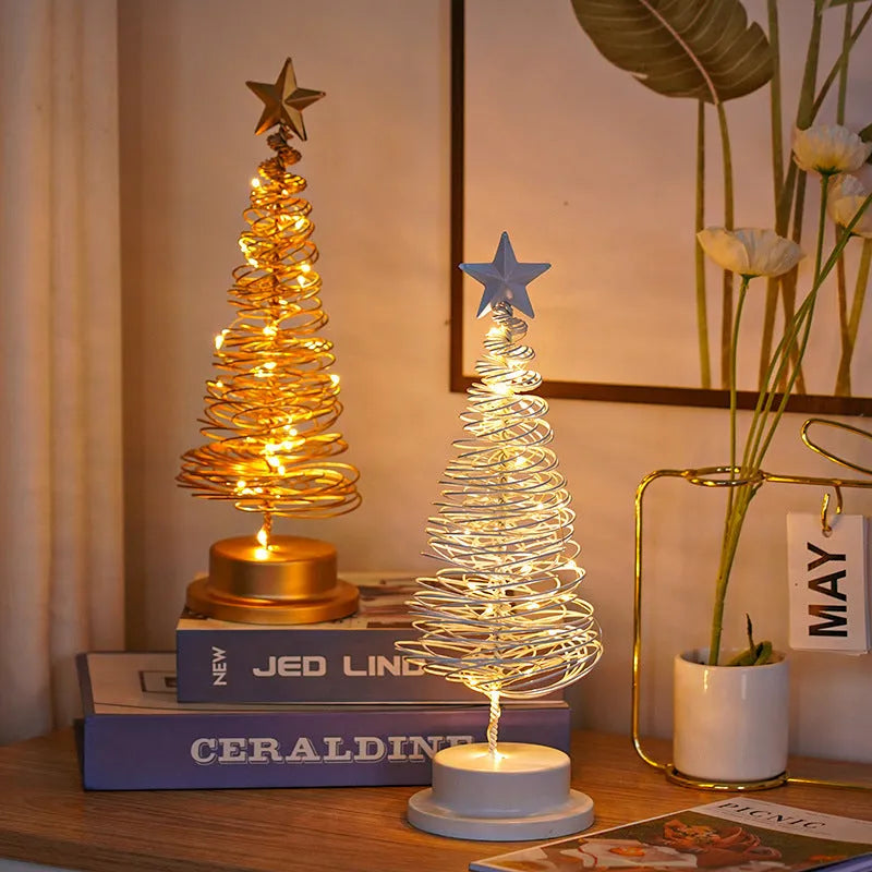 Wrought iron LED Christmas tree light with spiral design and warm white illumination on table