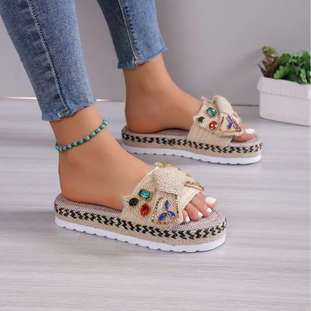 Creamy-white women's platform sandals with beach bow style and cloth construction on model foot