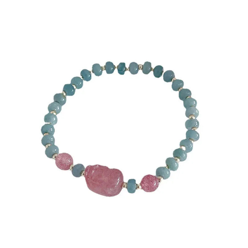 Blue-toned jade bracelet with gourd and peace buckle charms and strawberry quartz accents
